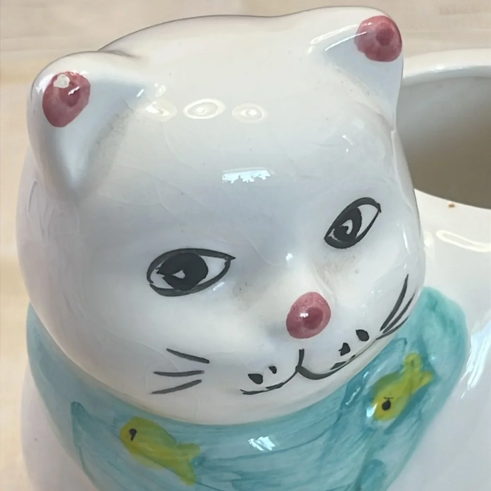 White Ceramic Cat-Shaped Planter with a Blue Scarf Adorned with Fish.